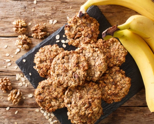 plate of cookies beside bananas