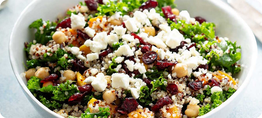 nourishing-quinoa-salad-featured-1 quinoa salad with kale, cranberries, goat cheese, chickpeas.